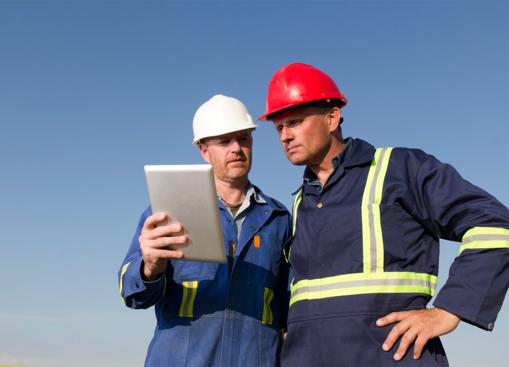 Two construction workers using tablet