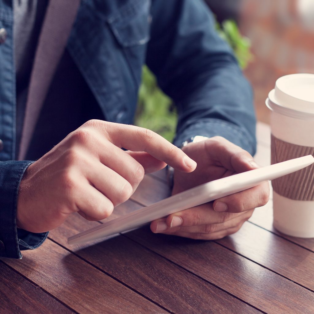 Using a tablet on a wooden table